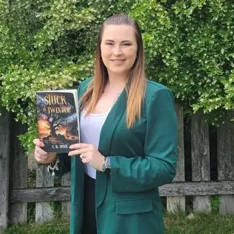 Person holding 'Stuck in Twindle' book.